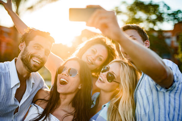istock Young happy friends taking a selfie with cell phone in nature. 1451030321
