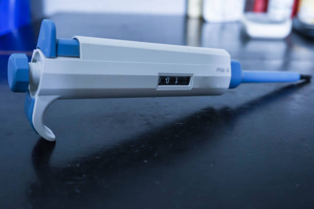 istock Automatic pipette, Micro pipettes, Micro chemical equipment laboratory Isolated on black table background 1451031580