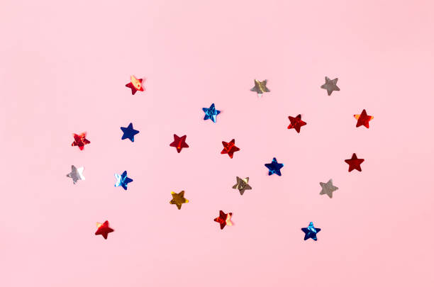istock Pink holidays background with sparling big sequins stars confetti. 1451031909