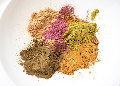 Henna powder. Henna paste. Prepare the henna paste at home. Still life with henna and dandelions. Focus on the powder