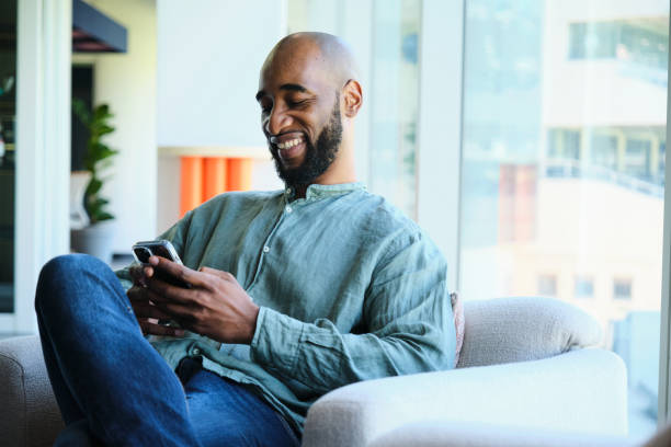istock Businessman laughing at a phone text during an office break 1451032002
