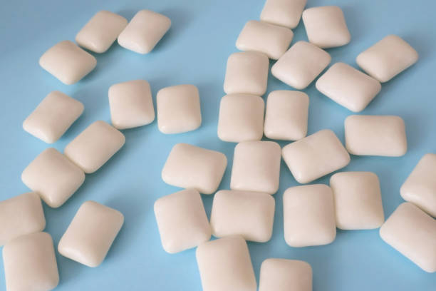 istock Chewing gum on a blue background in close up 1451032061