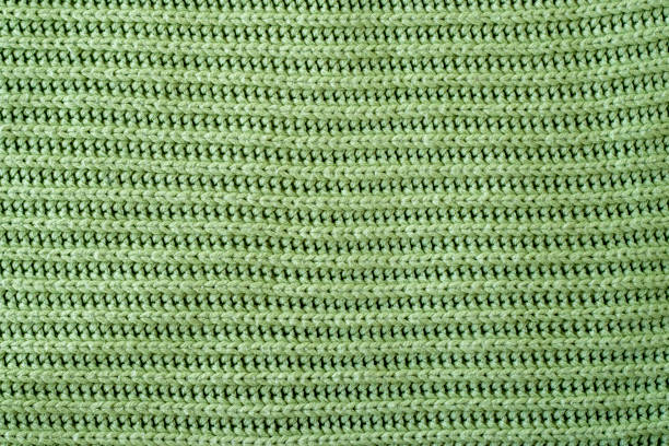 istock Beautiful green woolen knit fabric as background, top view. Handmade macro 1451032896