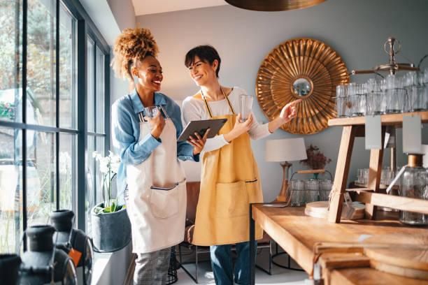 istock Two Smiling Colleagues Working Together In A Home Decor Store 1451035003