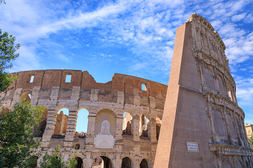 detail of the ancient perimeter walls upper corner of the Colosseum viewed from the outside with blue sky, Rome Italy