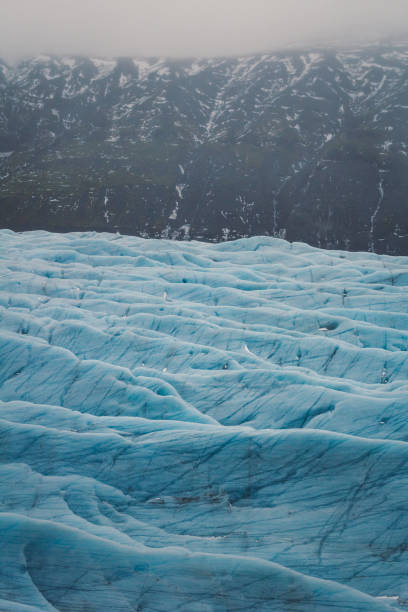 Ice field in ridge bottom landscape photo. Beautiful nature scenery photography with mountain on background. Idyllic scene. High quality picture for wallpaper, travel blog, magazine, article