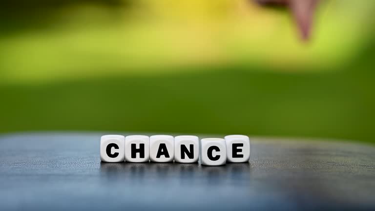 Hand is turning a dice and changes the word change to chance.