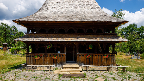 Surdesti, Maramures, Romania - July 07, 2022: The wooden church of Surdesti in Maramures Romania