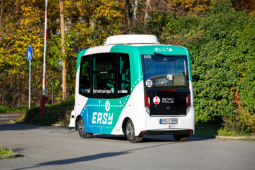 Frankfurt, Germany - November 21, 2022: Driverless transport system on the road in Frankfurt-Riederwald, Germany. The autonomous minibuses with the designation \