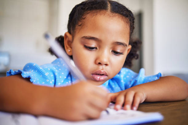 istock Home, notebook and kid drawing, writing or remote learning for preschool education, study and working on homework desk. Creative child development, home school and relax student girl with art talent 1451041842