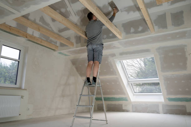 istock Man plastering drywall in a private house. 1451047797