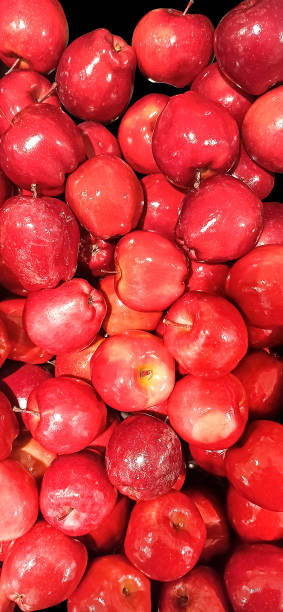 istock Background, many red, shiny apples, beautiful fruits. 1451048343