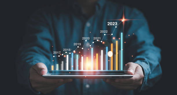istock Businessman holding tablet with virtual increasing technical graph and up arrow for trader analysis business stock market chart concept. 1451050111