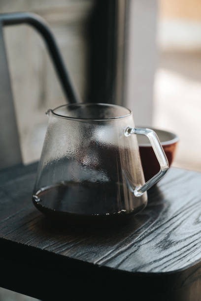istock Black coffee in glass teapot on small wooden table 1451053631