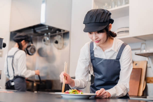 istock Two female staff working in a restaurant kitchen 1451055309