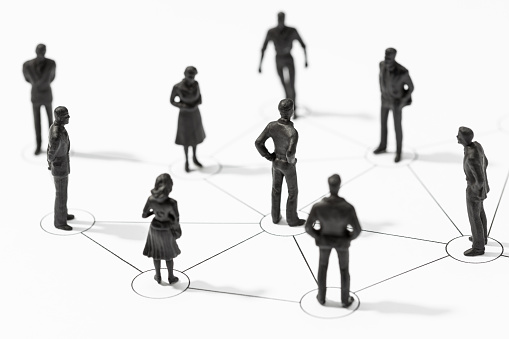 Group of Linked people figurines. Communication, teamwork, community, society, social network concept