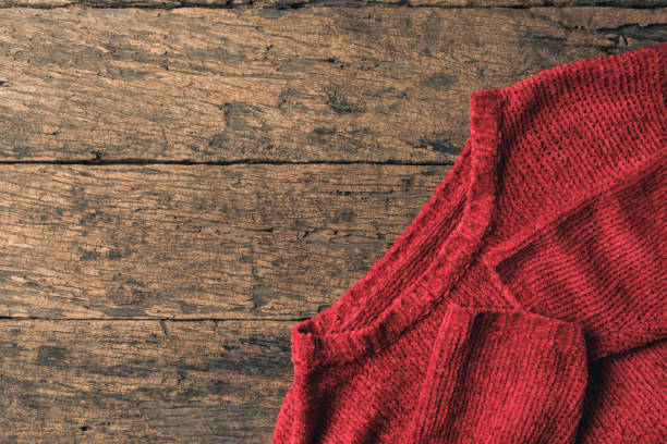 istock Red Sweater on Wooden Table. 1451063792