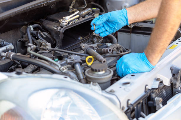 istock Ignition coil and car spark plug change or replacement. Repairing of vehicle engine. 1451063983