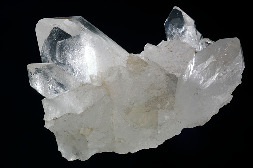 Pure quartz crystal isolated on the black background.