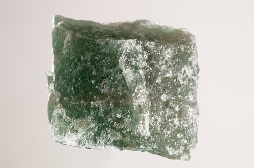 Green quartz crystal isolated on the white background.
