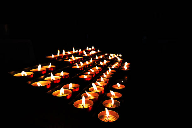 istock A black background with many yellow candles 1451065650