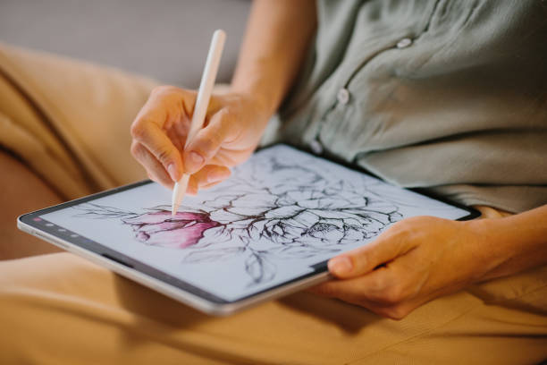 istock Artist or designer making new project, drawing on a graphic tablet with pencil, close-up on a screen. 1451066748