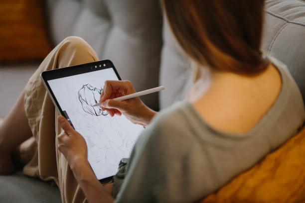 istock Artist or designer making new project, drawing on a graphic tablet with pencil, close-up on a screen. 1451066848