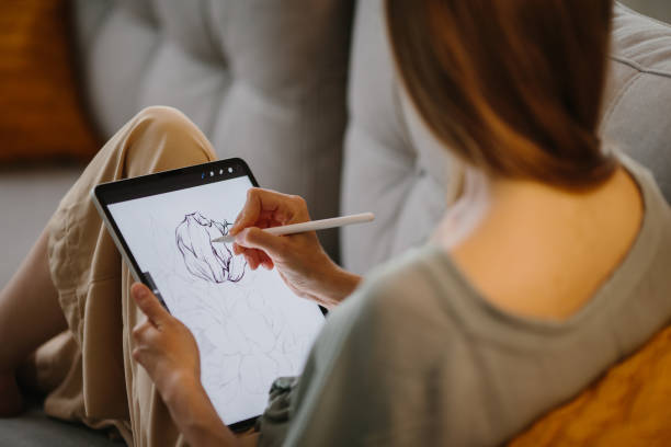 istock Artist or designer making new project, drawing on a graphic tablet with pencil, close-up on a screen. 1451066852