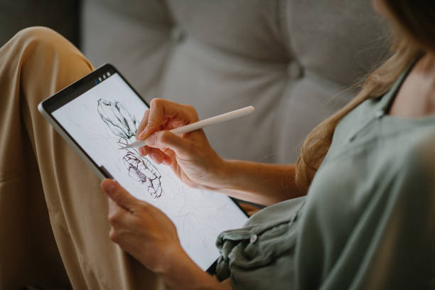 istock Artist or designer making new project, drawing on a graphic tablet with pencil, close-up on a screen. 1451066866