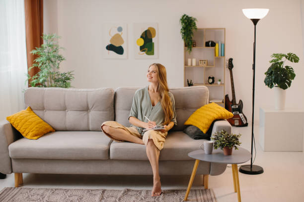 istock Happy young designer drawing on a graphics tablet with a stylus pen. Female graphic designer smiling while working on a new design. Creative young freelancer working in her home office. 1451066896