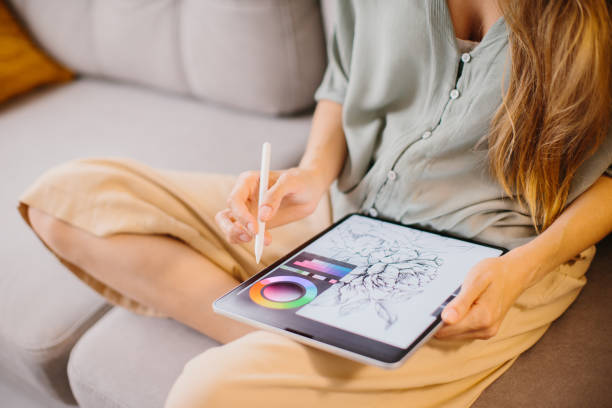 istock Artist or designer making new project, drawing on a graphic tablet with pencil, close-up on a screen. 1451067814
