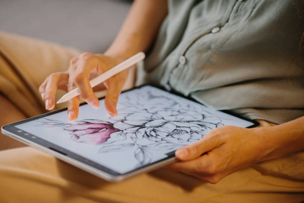 istock Artist or designer making new project, drawing on a graphic tablet with pencil, close-up on a screen. 1451067815