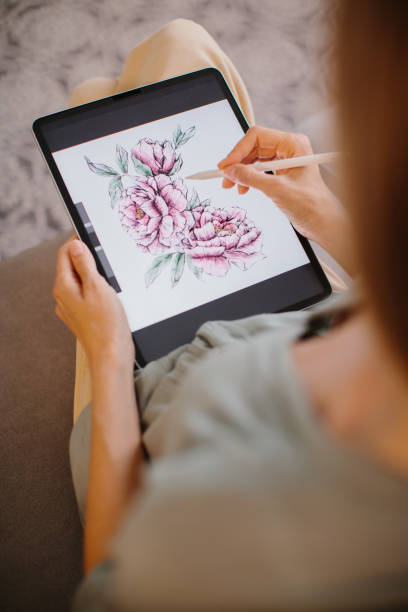 istock Artist or designer making new project, drawing on a graphic tablet with pencil, close-up on a screen. 1451068395