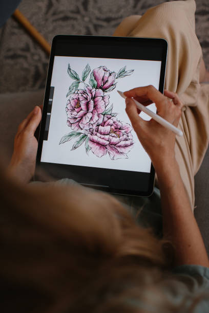 istock Artist or designer making new project, drawing on a graphic tablet with pencil, close-up on a screen. 1451068397