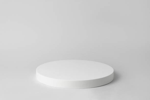 istock Empty white podium on light grey background. Minimal template. Round showcase for cosmetic product advertising. Abstract display or showcase. Spa and beauty mockup. Front view. Copy space 1451070370
