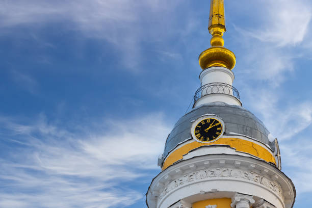 Clock with Roman numerals on the dome of the Orthodox Church against the blue sky. Background with copy space