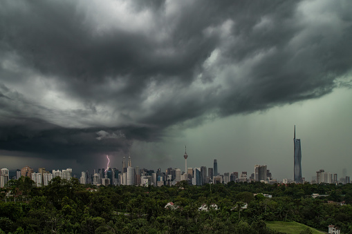 A lightning strike near Petronas Twin Tower with the appearance of big dramatic clouds in Kuala Lumpur