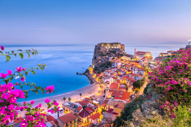 Scilla, Italy on the Mediterranean Coast at Twilight Scilla, Italy on the Mediterranean coast at twilight with seasonal flowers. castle scilla stock pictures, royalty-free photos & images
