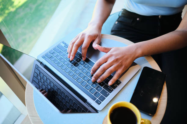 istock Young businesswoman working on a laptop during a coffee break 1451072267