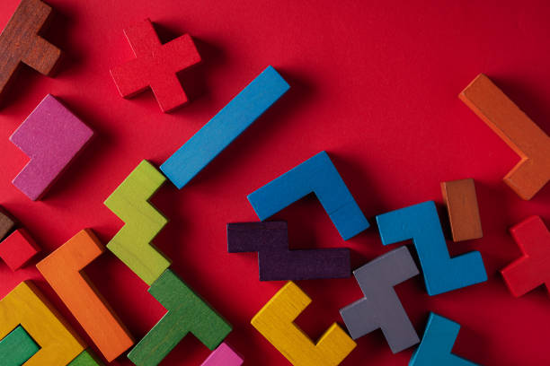 istock Top view on colorful wooden blocks folding on red background 1451073818