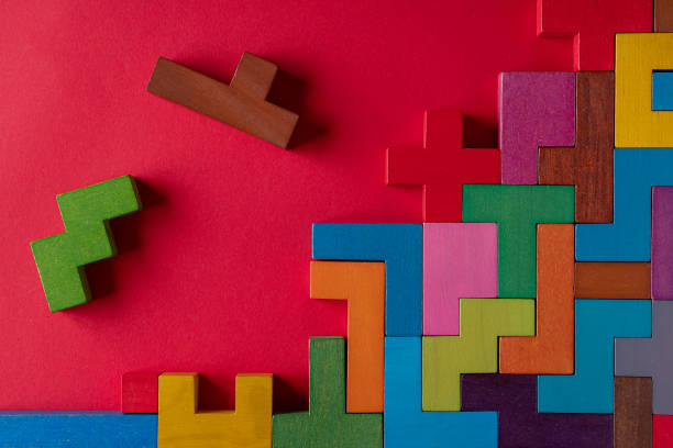 istock Top view on colorful wooden blocks folding on red background 1451073833