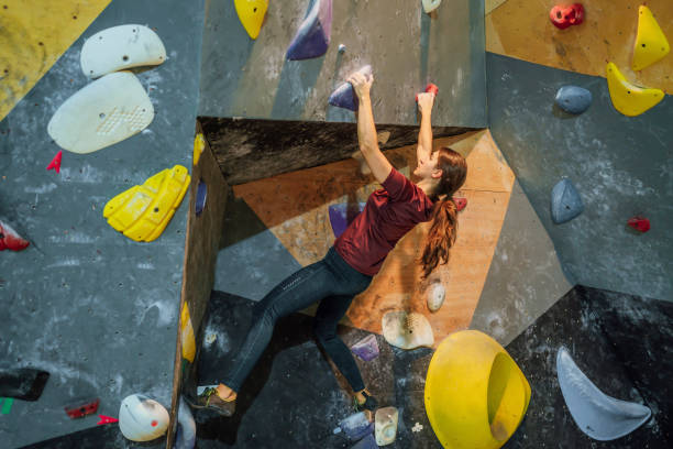 istock Woman climbing bouldering wall 1451074967