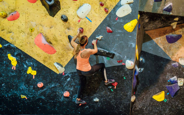 istock Woman climbing bouldering wall 1451076234