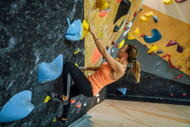 istock Sportswoman training climbing on indoor climbing wall 1451077211