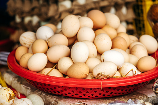 Top view on a assortment of loose eggs on a market