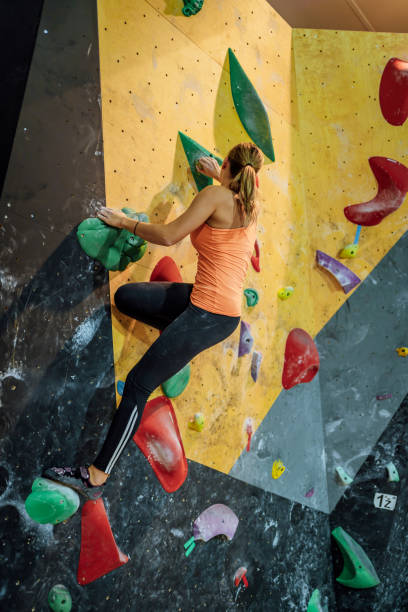 istock Sportswoman training climbing on indoor climbing wall 1451077550