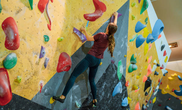 istock Woman climbing on the artificial climbing wall 1451077713