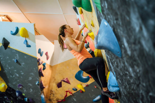 istock Woman on climbing wall with colorful artificial elements 1451078432