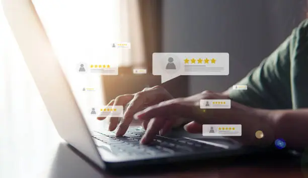 Photo of Customer review good rating concept, hand pressing user and five star icon on visual screen for positive customer feedback, testimonial and testimony, user comment and feedback for review.