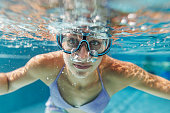 Underwater portrait of a teenage girl at the swimming pool